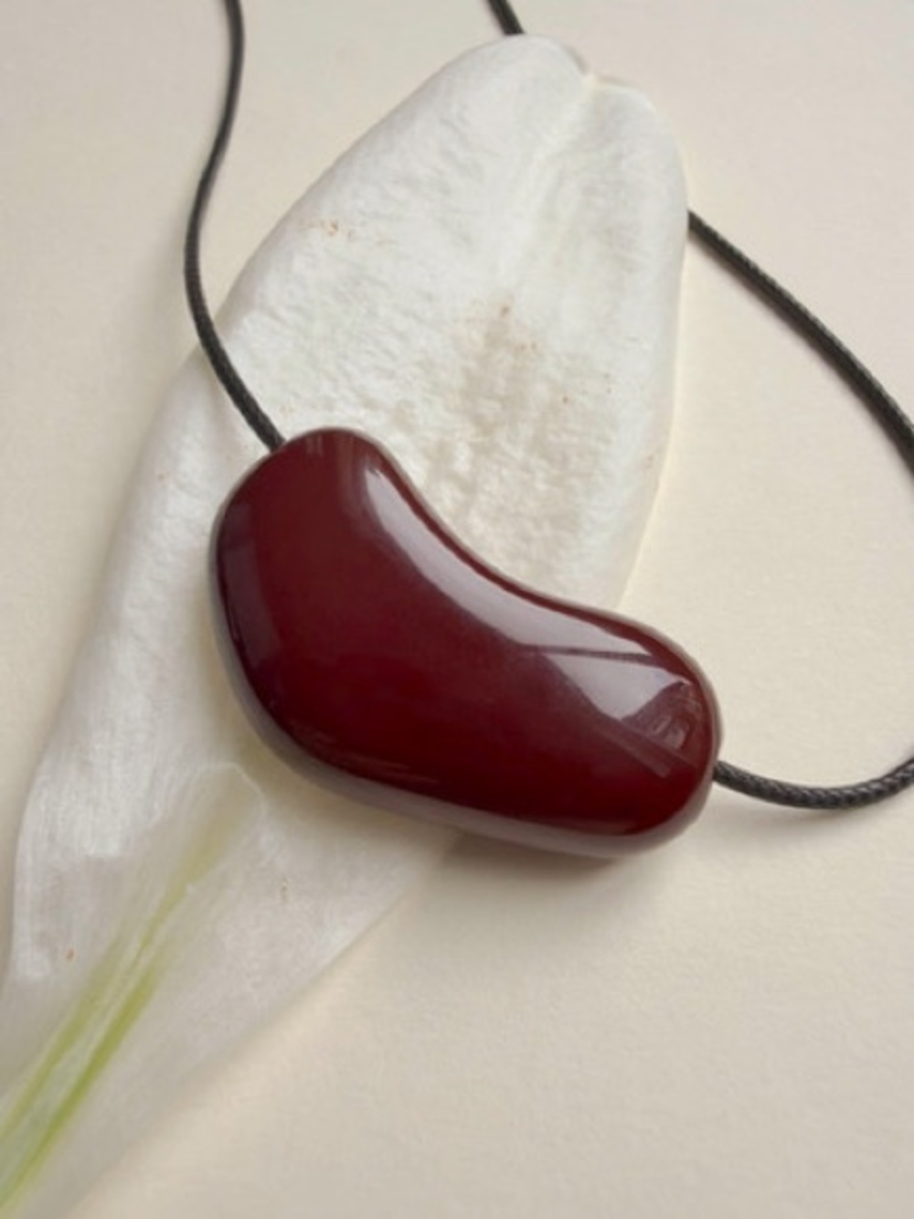 Burgundy Red Sculptural Bean Pendant Necklace Black Cord Modern Minimalist